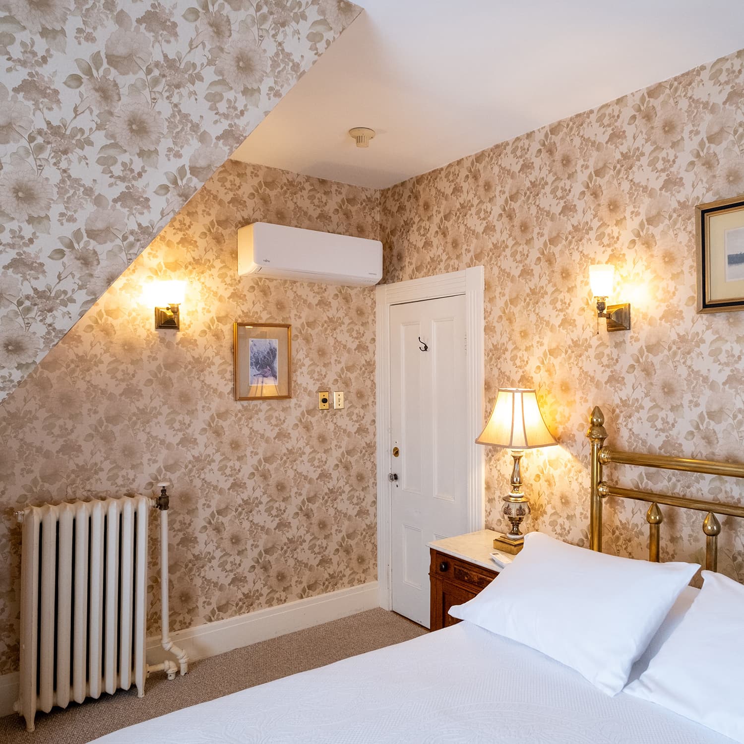 A bedroom with a wall-mounted mini split