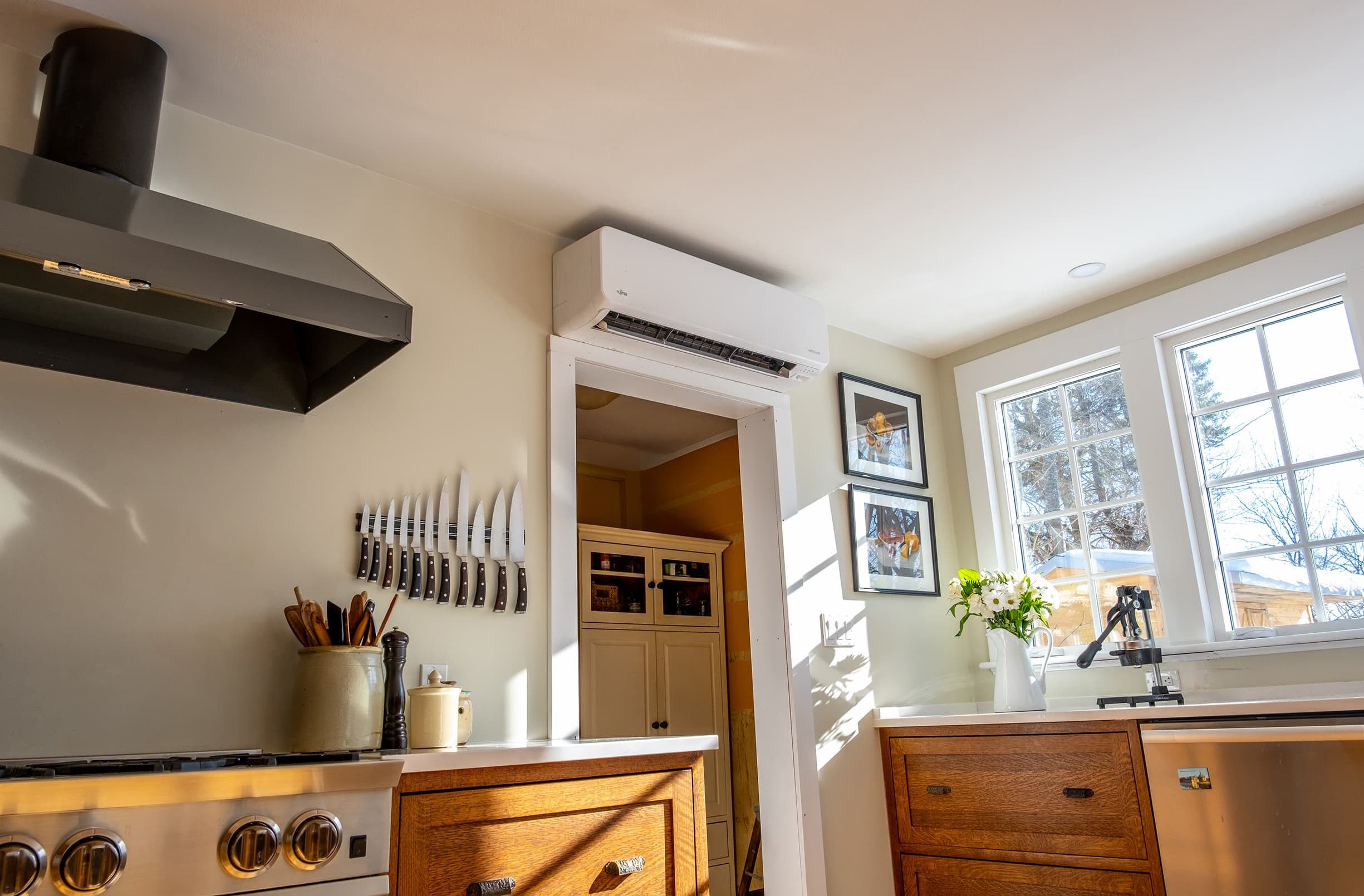 A kitchen with a wall-mounted mini split