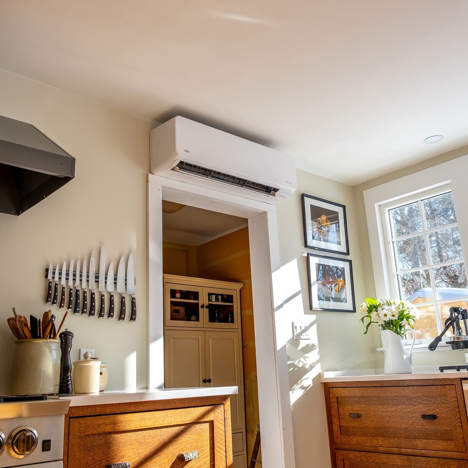 A kitchen with a wall-mounted mini split
